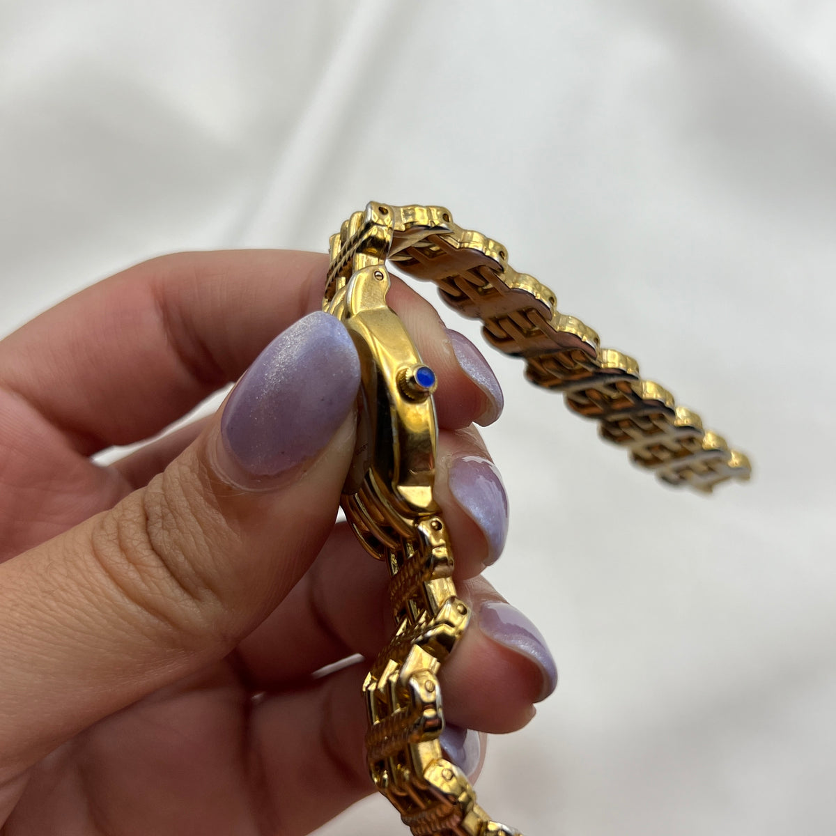 Chic Gold-Toned Watch with Blue Gem Crown