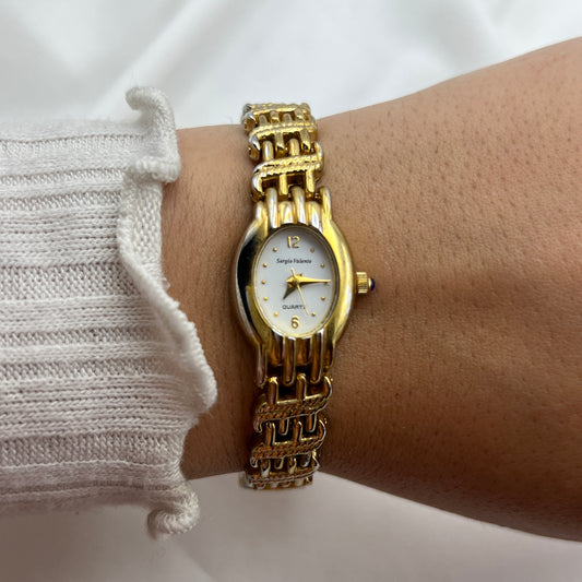 Chic Gold-Toned Watch with Blue Gem Crown
