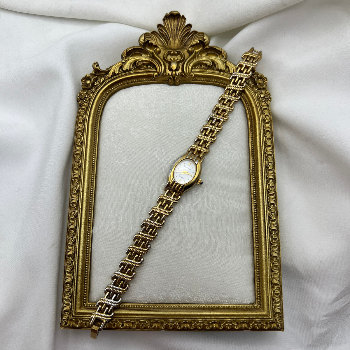 Chic Gold-Toned Watch with Blue Gem Crown