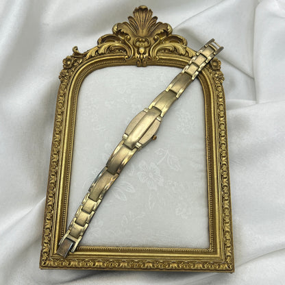 Gold Tone Peek a Boo Watch with Ruby Detailing
