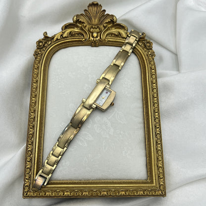 Gold Tone Peek a Boo Watch with Ruby Detailing