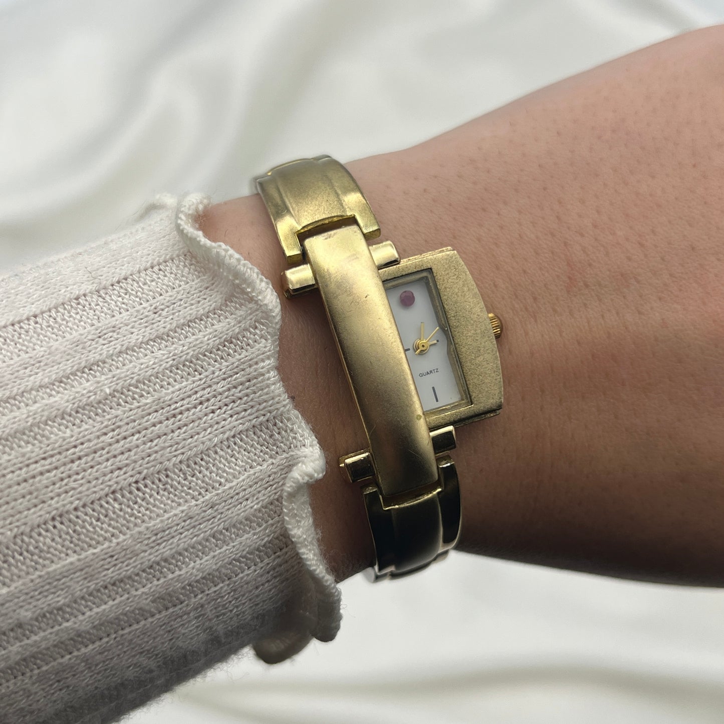 Gold Tone Peek a Boo Watch with Ruby Detailing