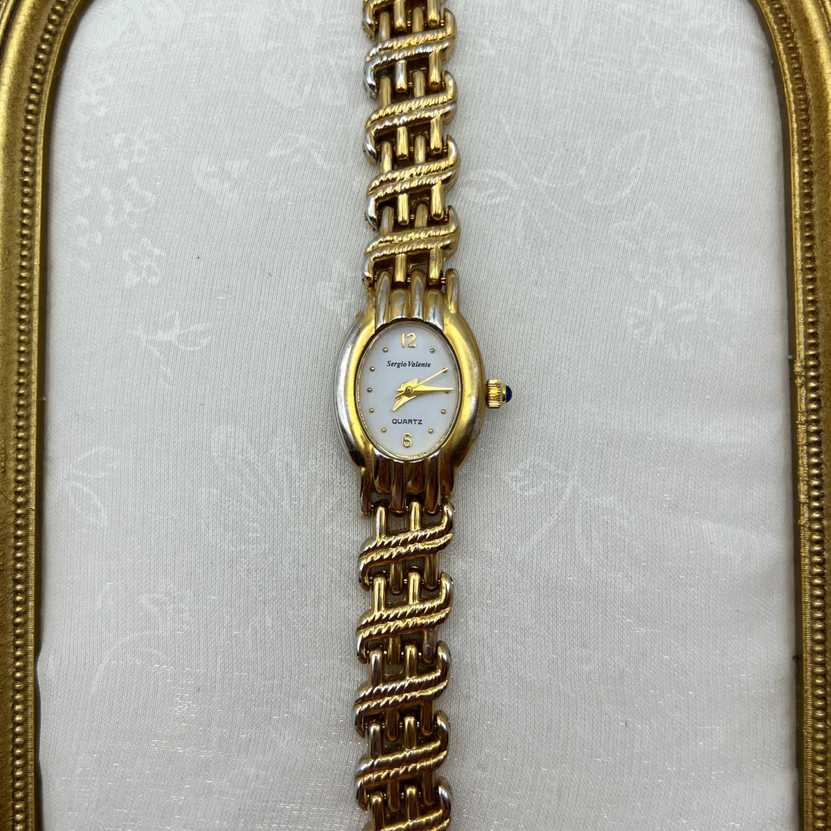 Chic Gold-Toned Watch with Blue Gem Crown